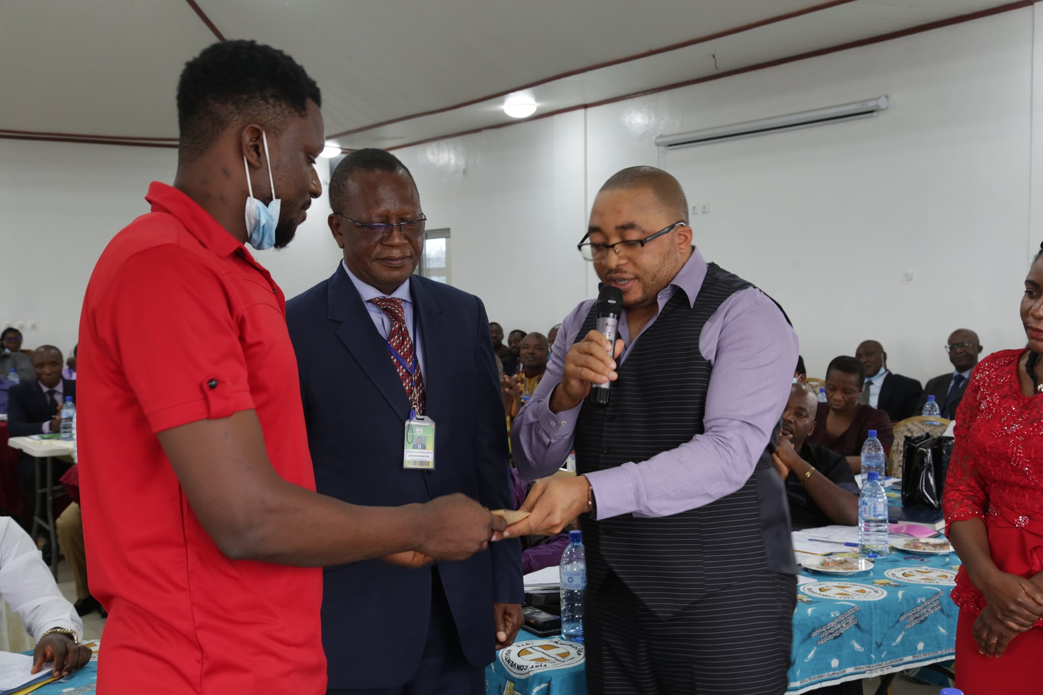 SPD Coordinator on behalf of the CBCHS hands fanacial support to the National Amputee Football team during the Chief of Centers meeting in Yaounde