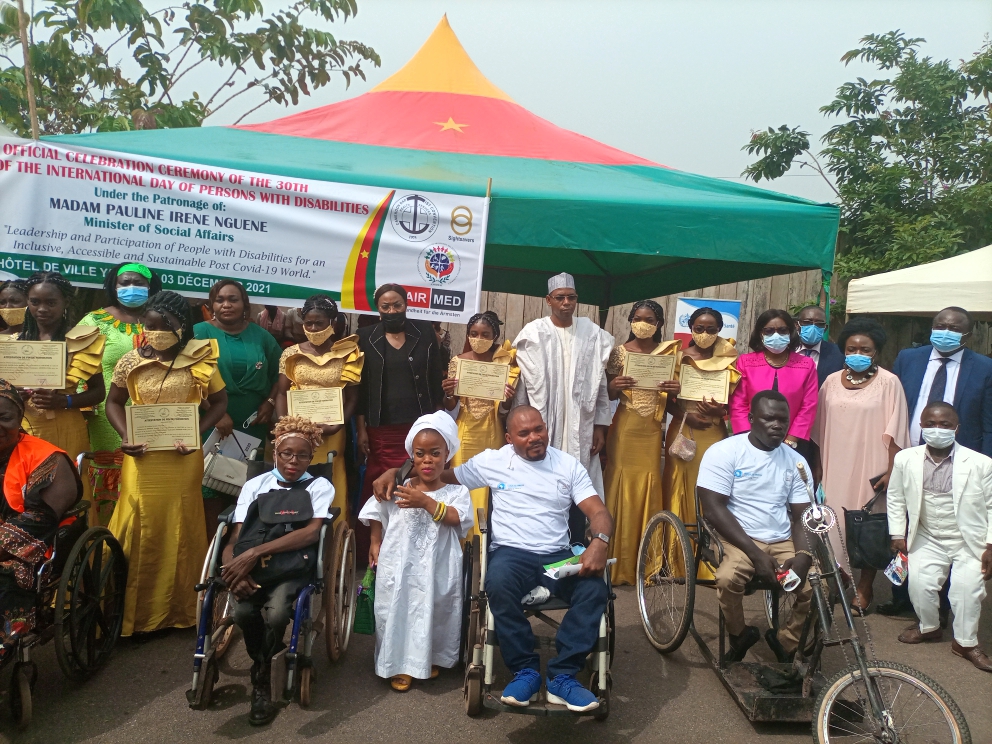 Stakeholders poses with Persons with disabilities
