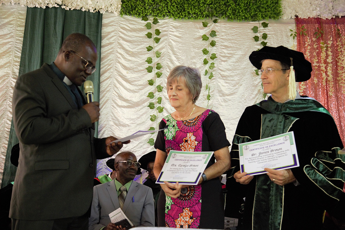 The Executive President of CBC handing certificates of recognition to Dr James Brown and Carolyn Brown