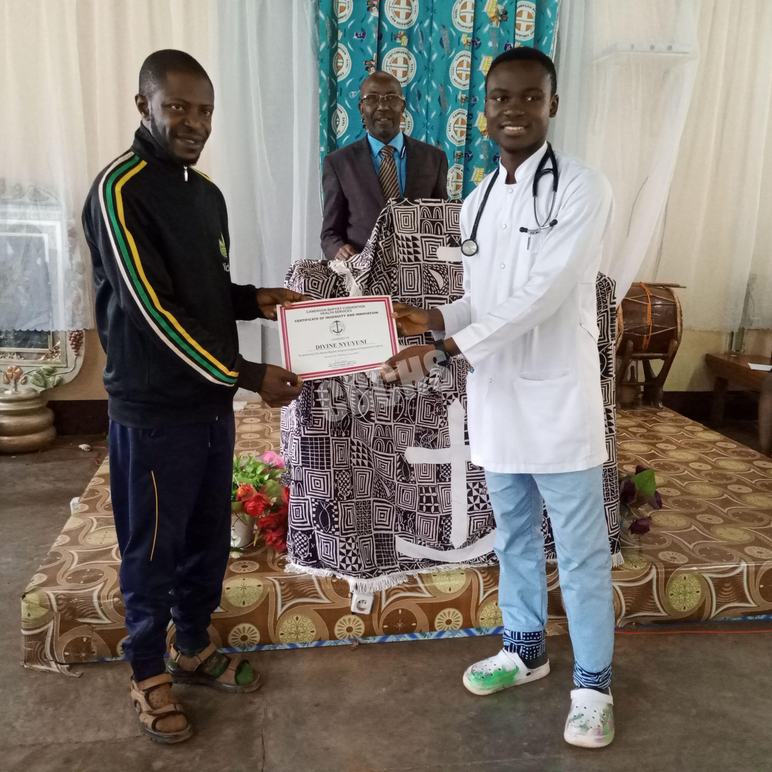 Representative of CMO of BBH, Dr. Taku Samuel handing over certificate of recognition to Mr Nyuyyuni Divine