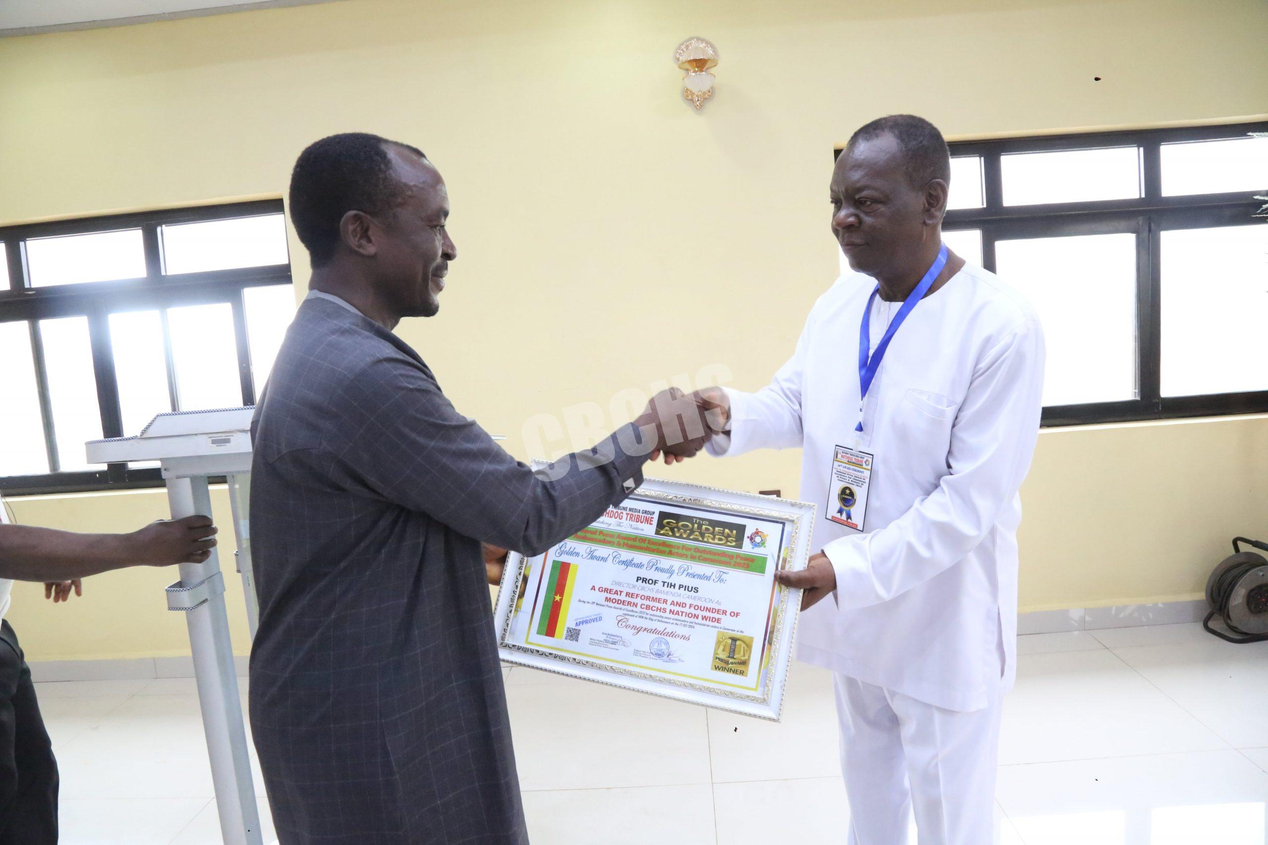 Watchdog Media Group Publisher, Ezikiel Nkunawe Dotta, offering award to Prof. Tih, DHS