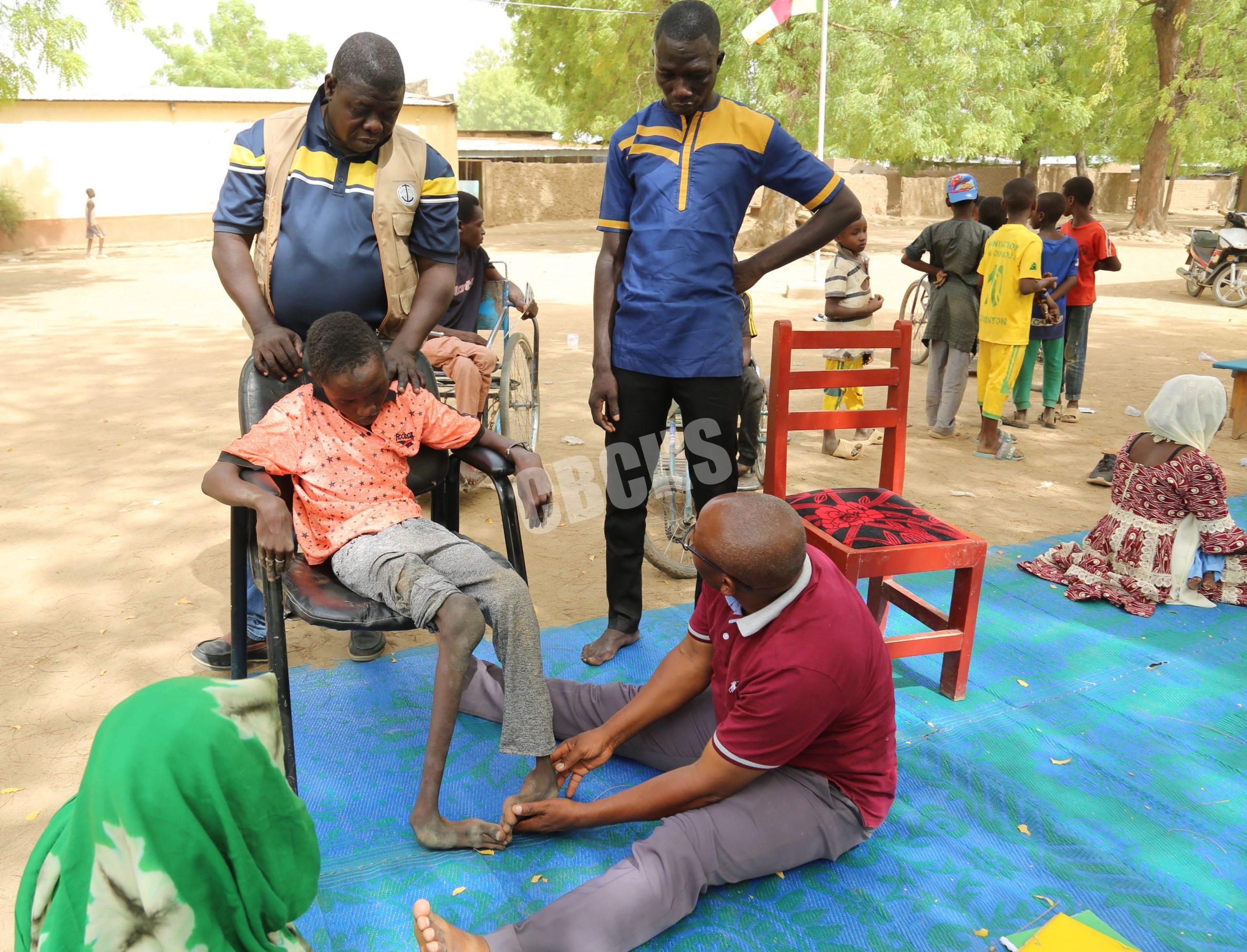 Mr. Kenchi assessing a pupil with disabilities