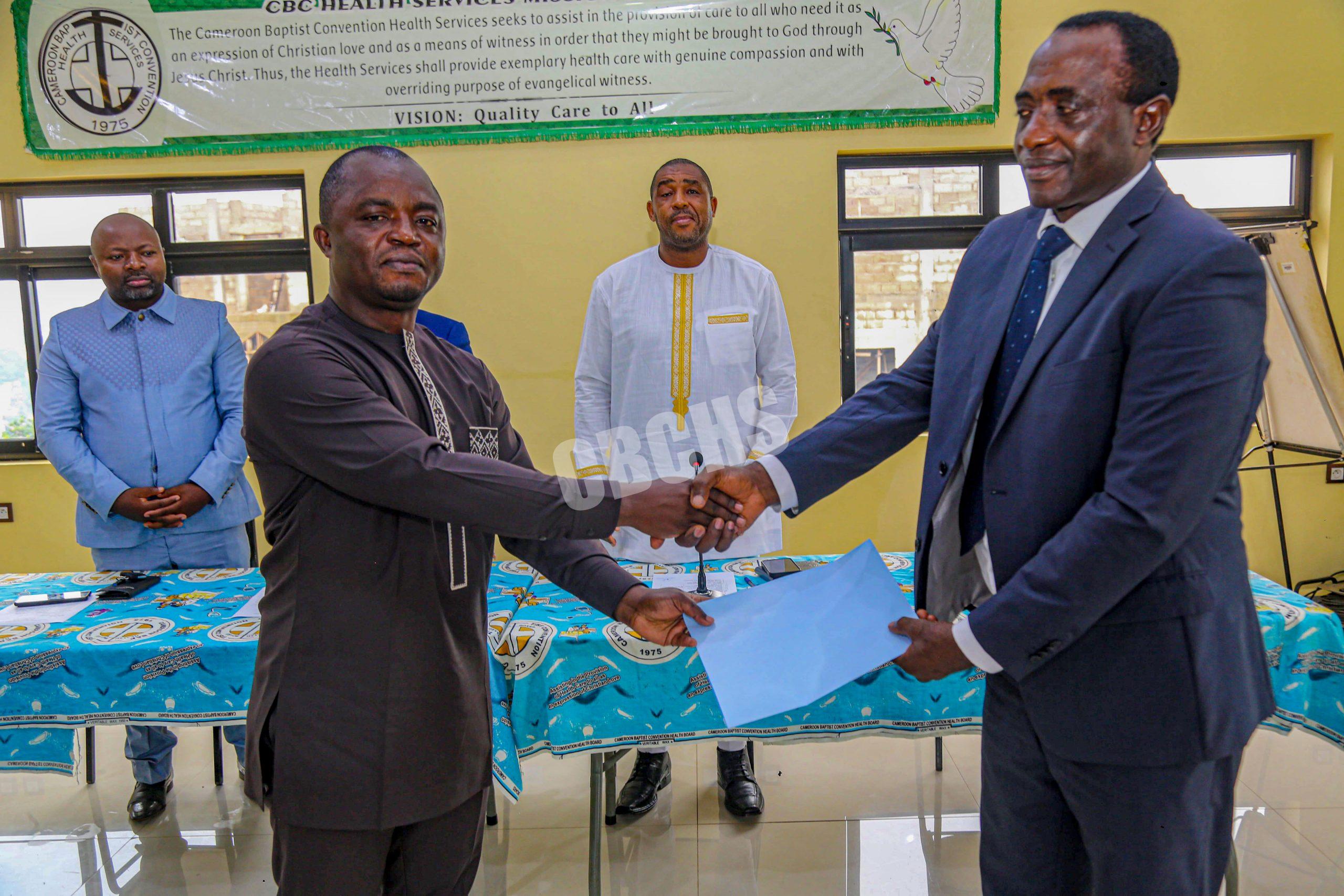 Dr. Nshom Ernest (left) assumes the role of Supervisor of Anesthesiology Services from Mr. Mbah John