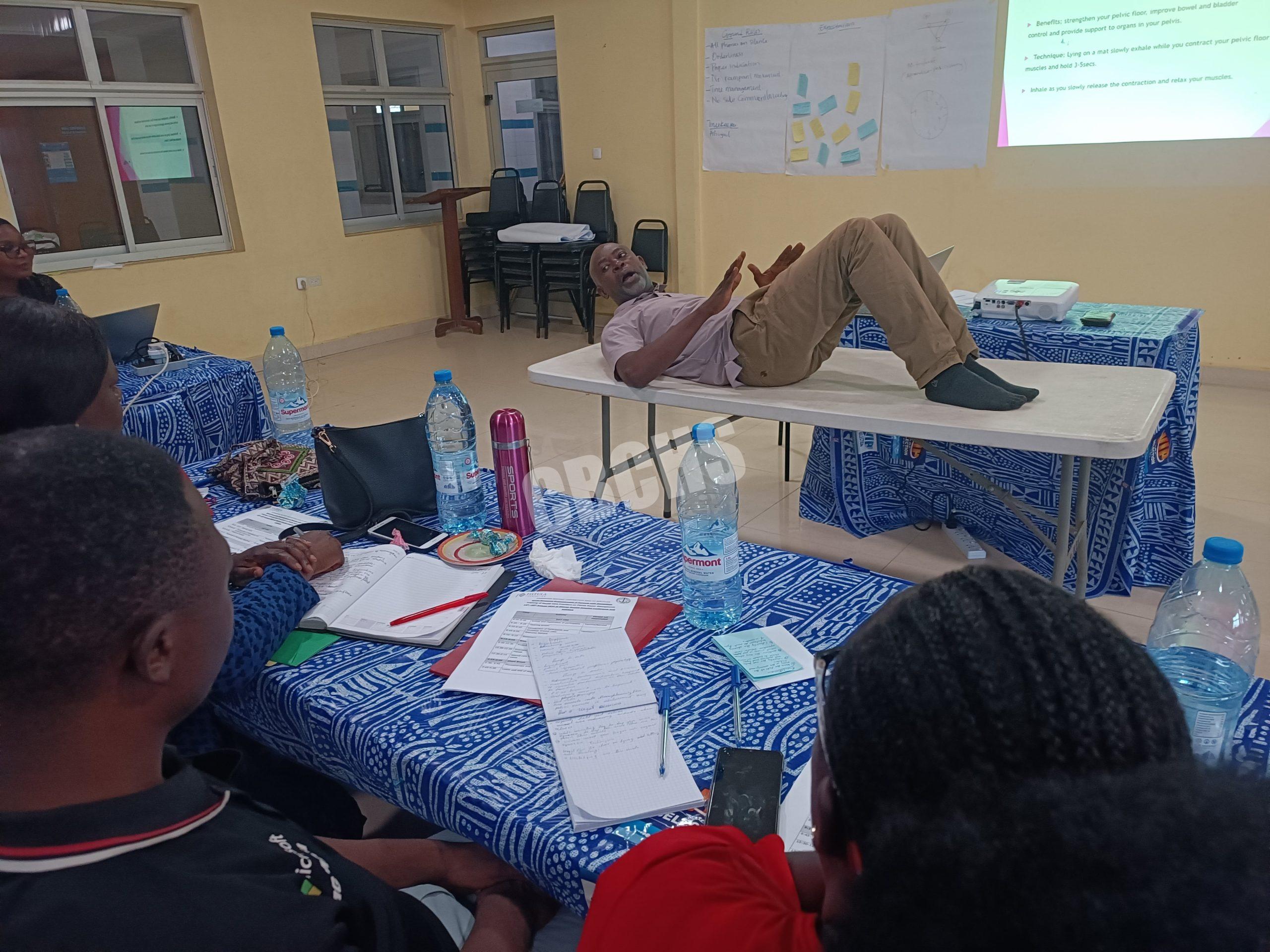 Physiotherapist demonstrating a pelvic floor strengthening exercise