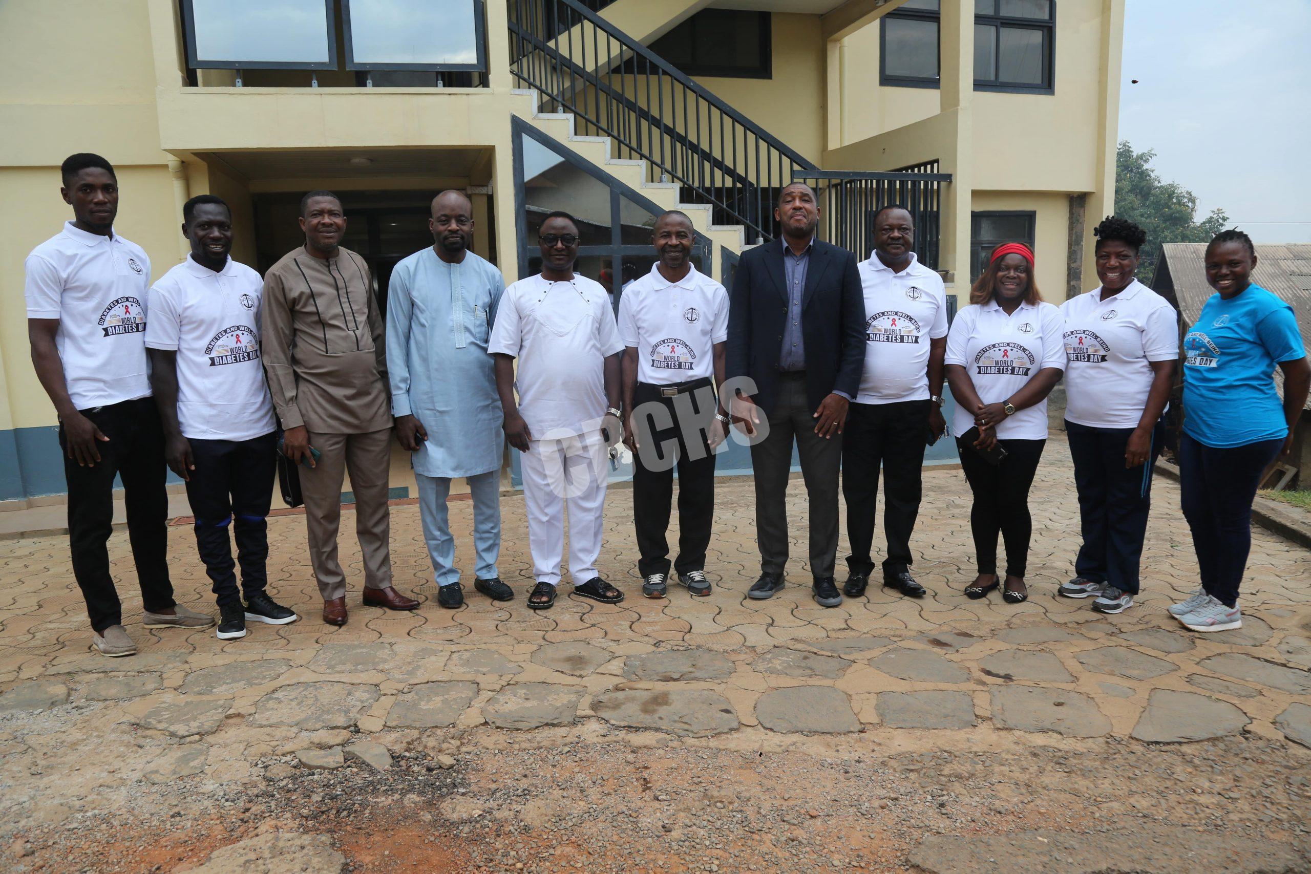 DHS (in suit) poses with NCD team and other Administrators at the Central Administration