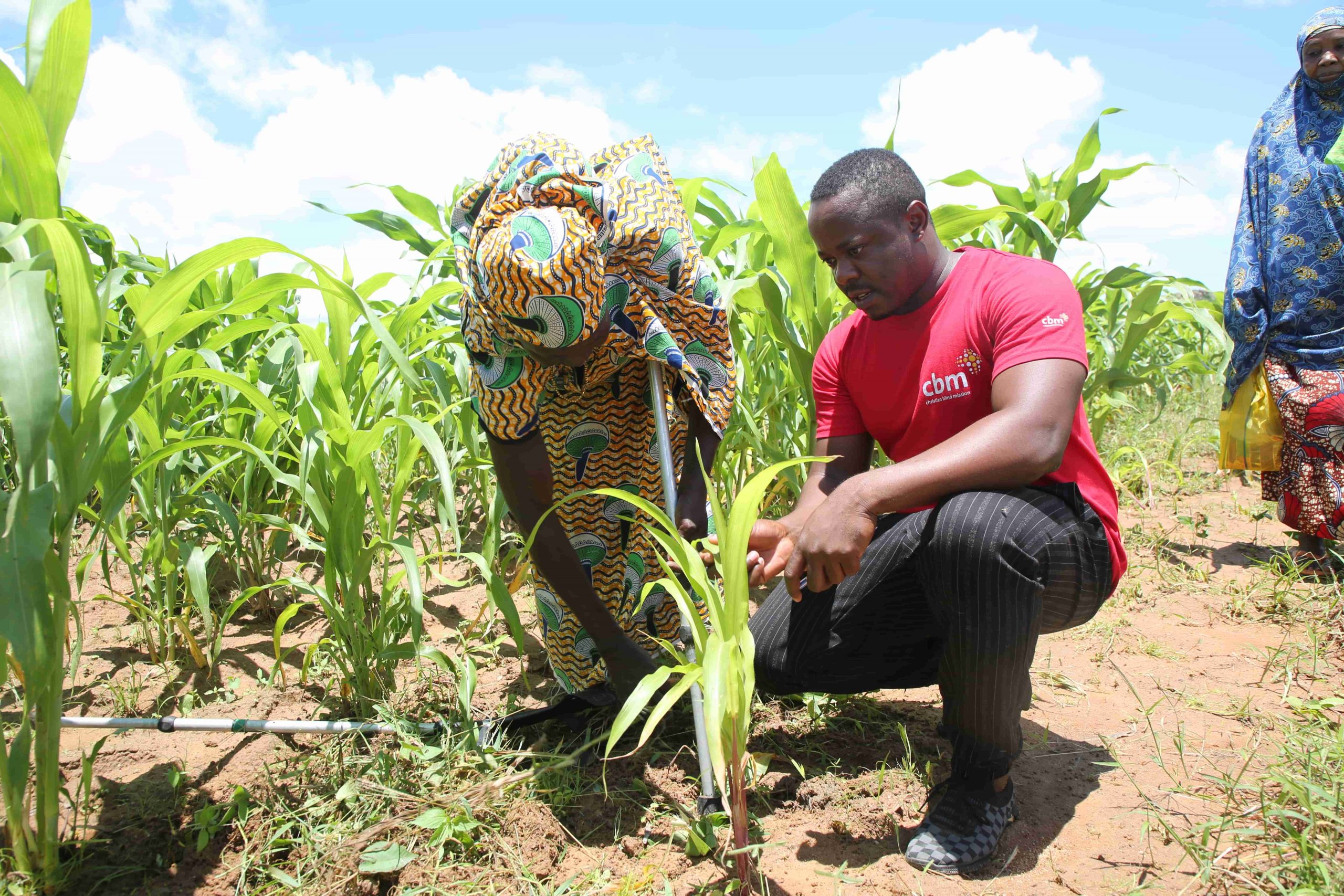 The CBID Officer for the project in discussion with a woman with a disability