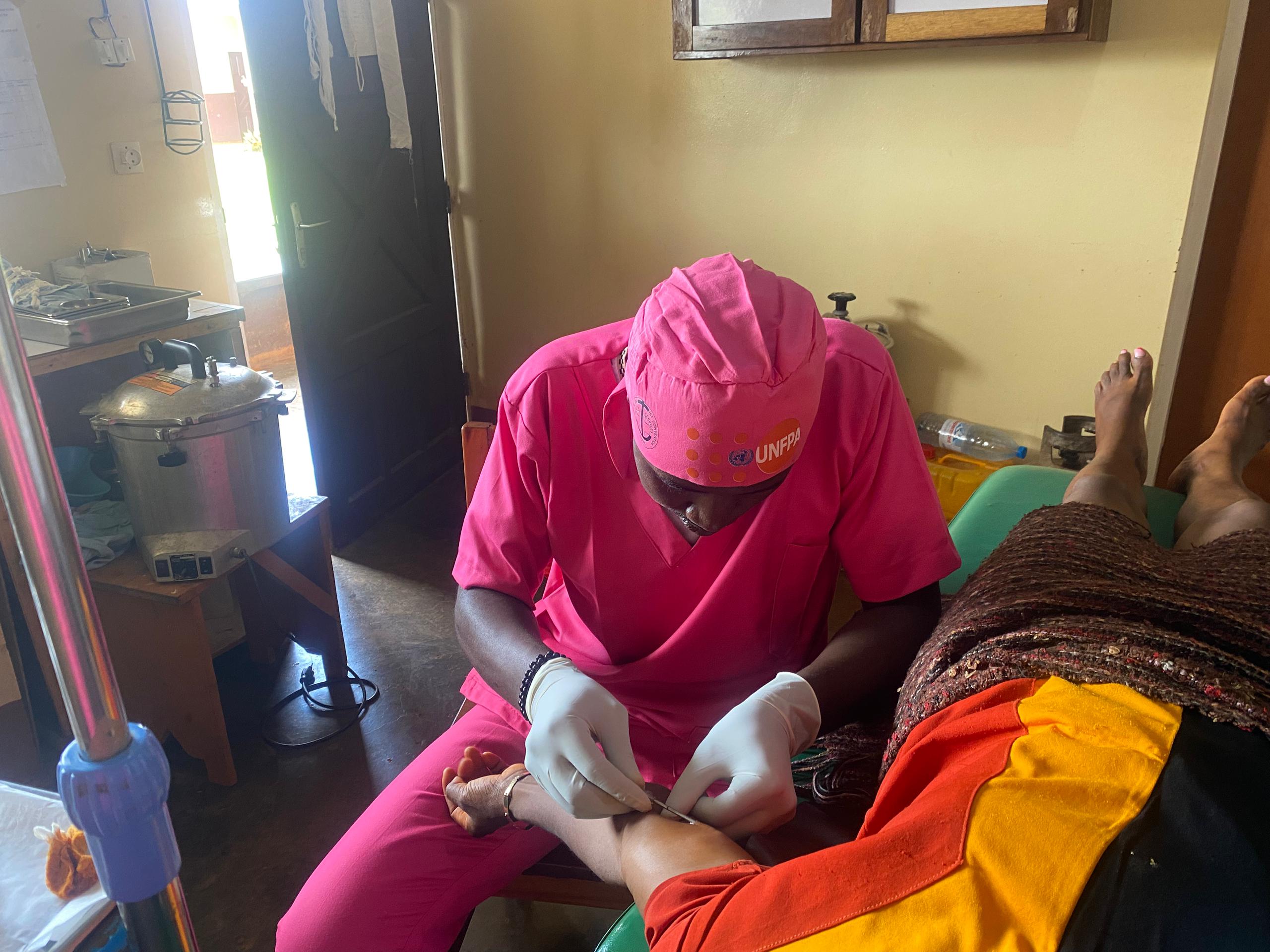 Midwife undergoing a family planning procedure to a client