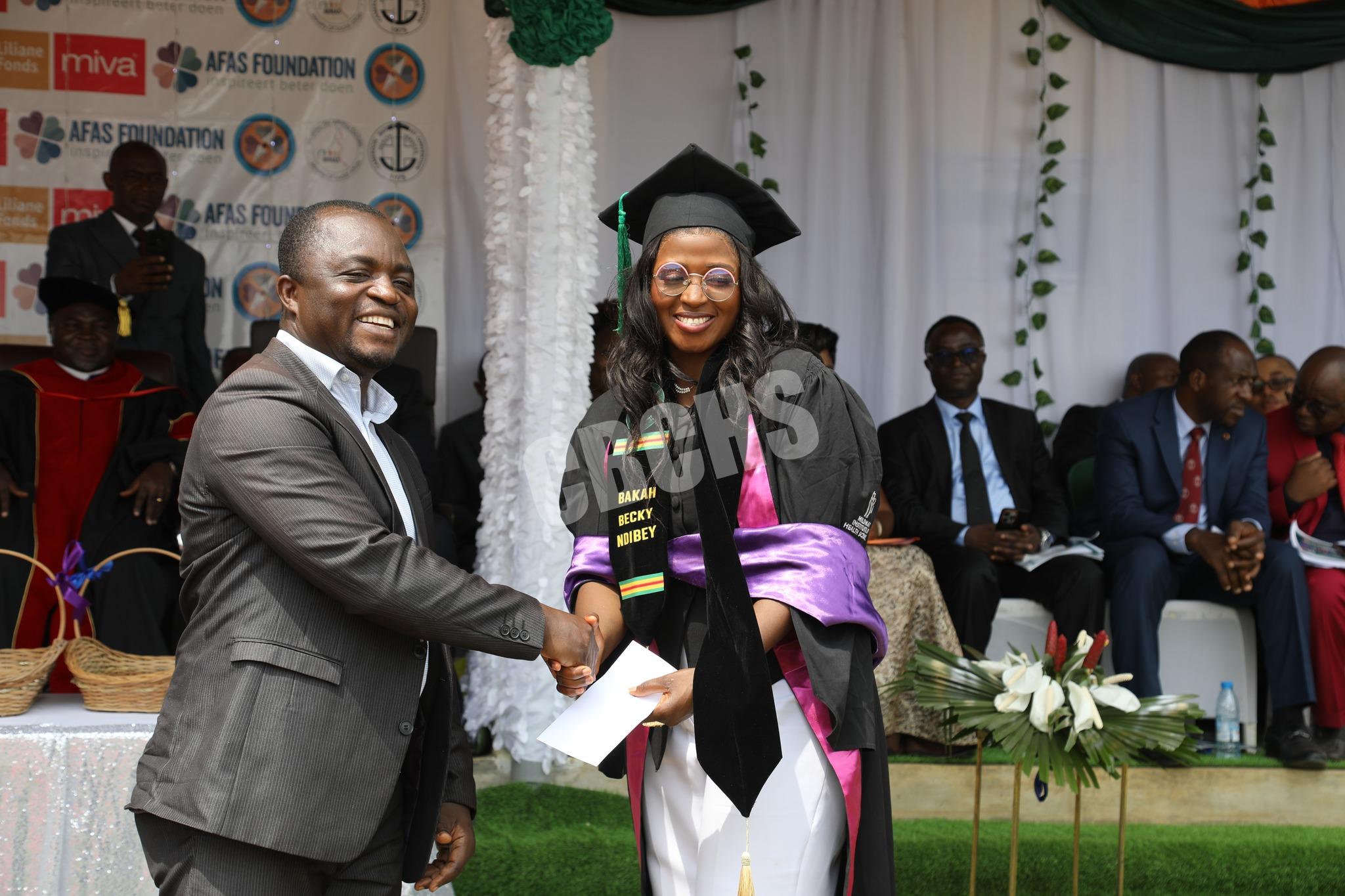 CMO of Mbingo Baptist Hospital, Dr. Nhom congratulating a graduand