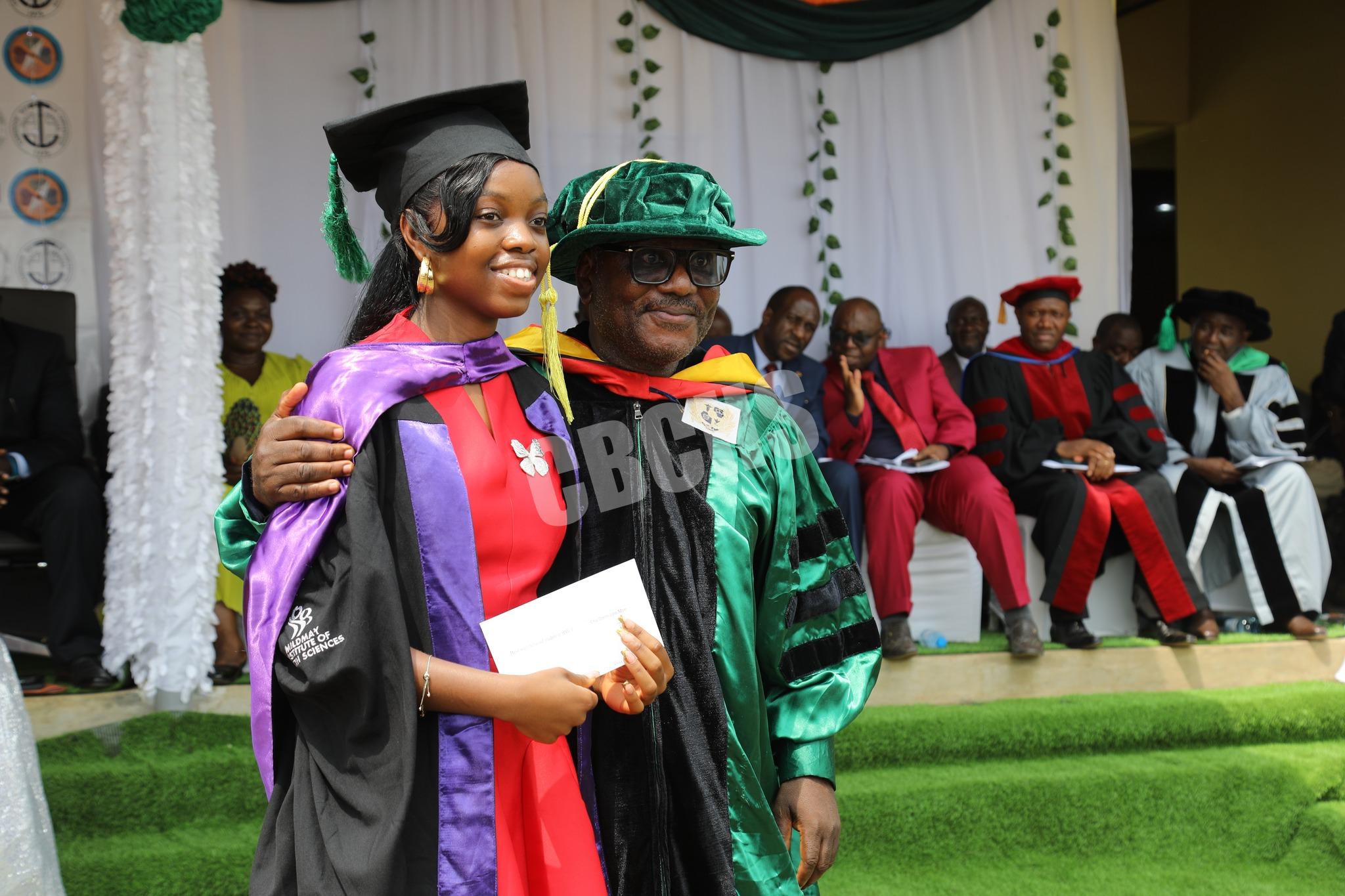 Dean of BSPH, Dr. Nkuoh Godlove congratulating one of the outsanding students