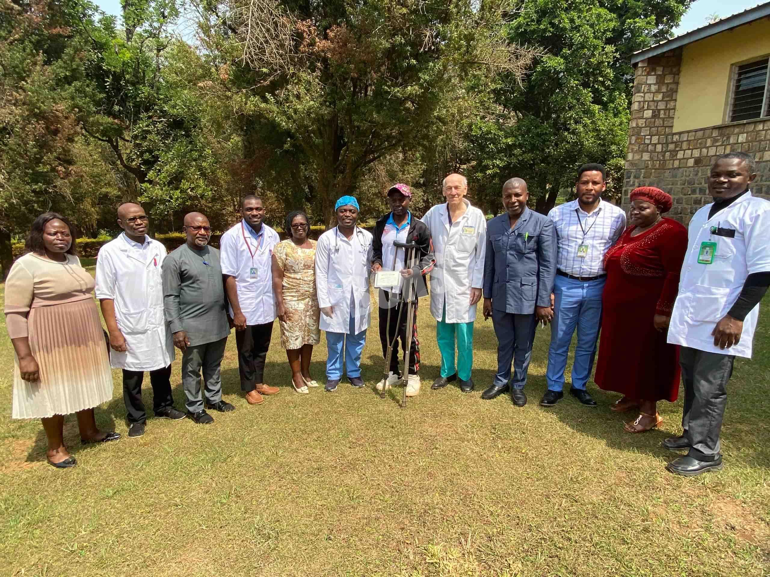 Discharged leprosy patient, Mr. Kawep pose with MBH adminmistration