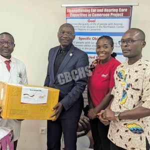 CBM Country Director (in black) handing over equipment to CHU Director General (In white)