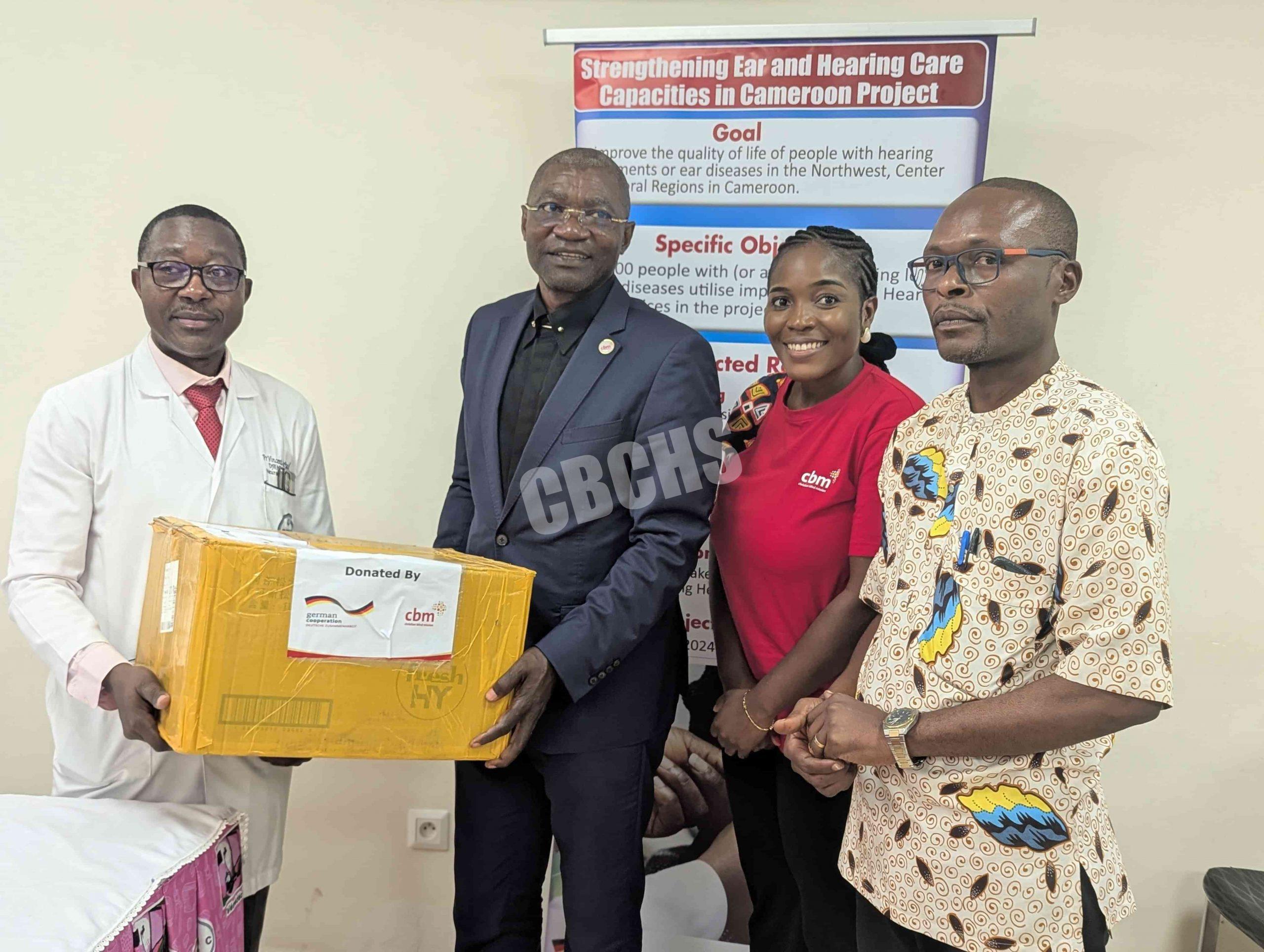 CBM Country Director (in black) handing over equipment to CHU Director General (In white)