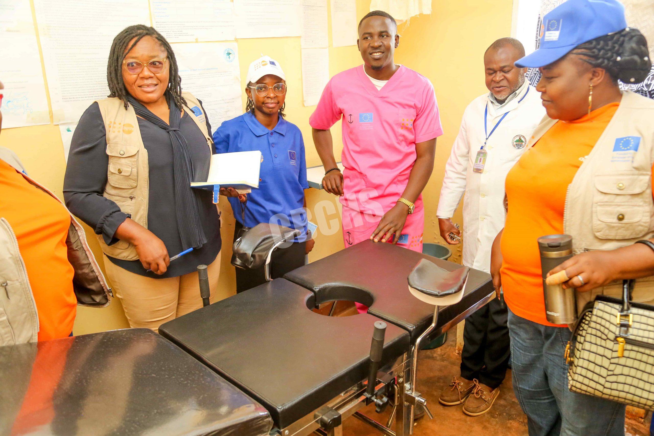 The Ashong COC flaunts the newly donated maternity bed to the project inspection team