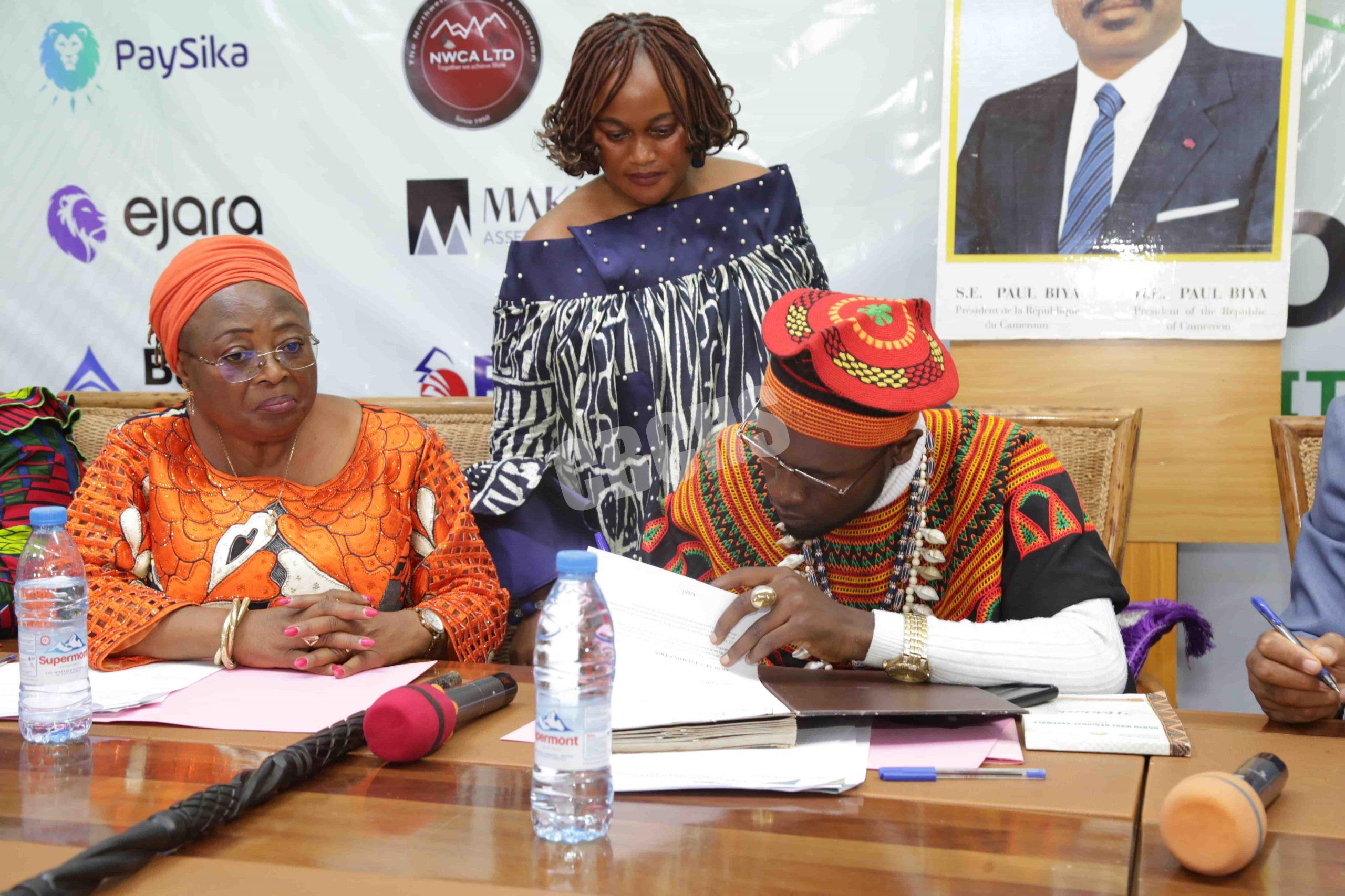 HRM Nfor Amidu signing MoU as Commissioner for Health (left) looks on