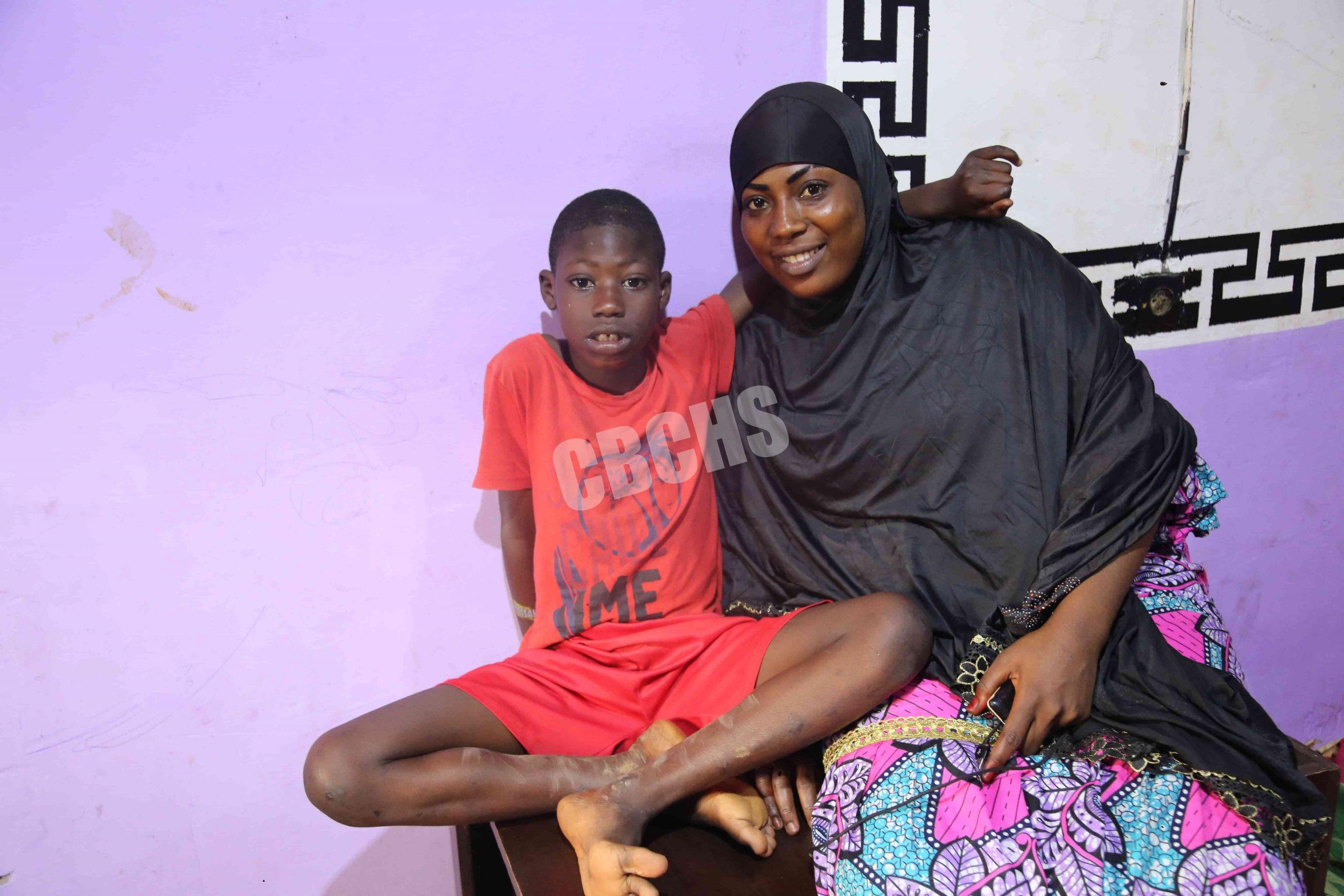 Cherif wraps his arms around his mother’s shoulders, both smiling—a beautiful moment capturing their deep and special bond.