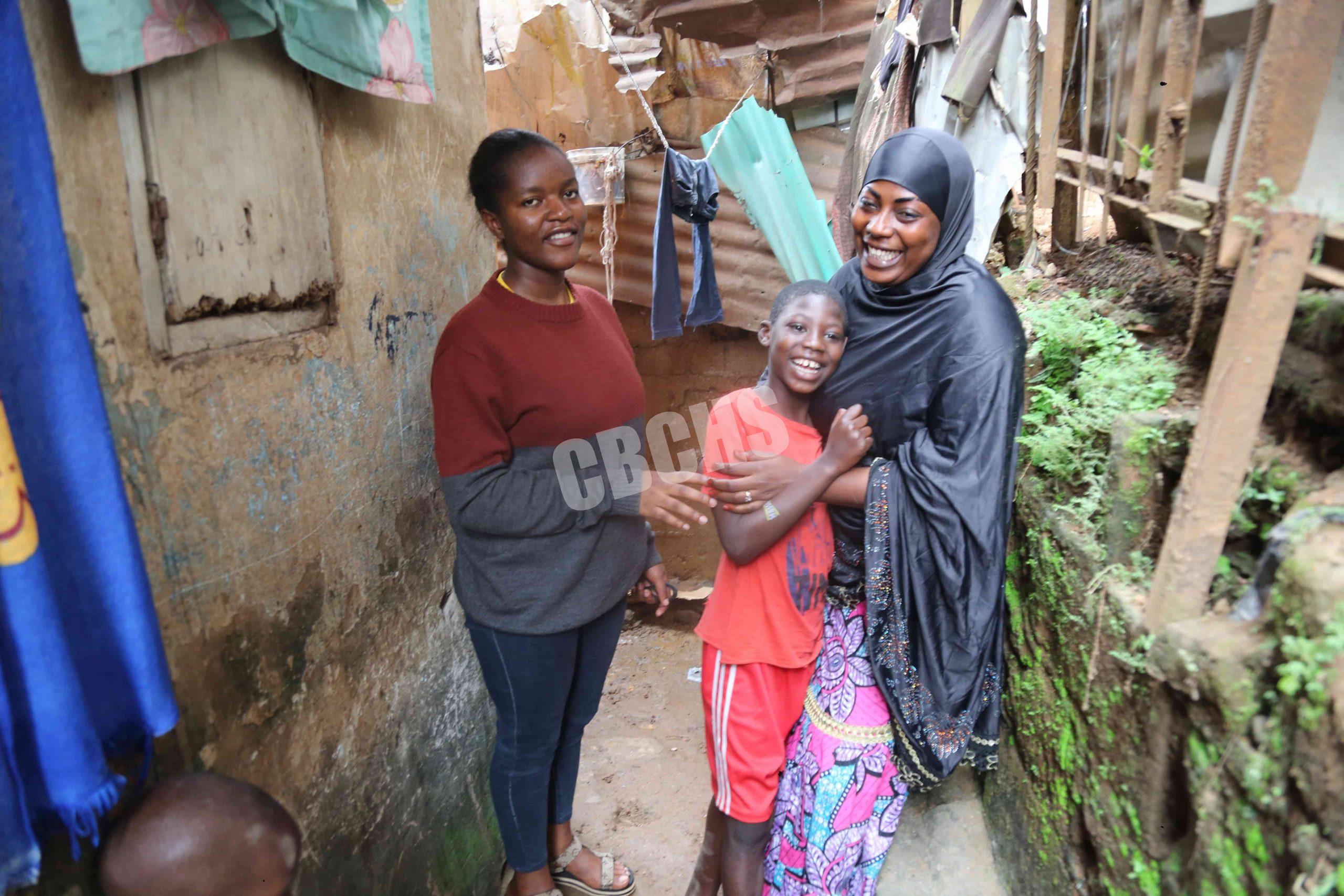 Fanny from APESH, Cherif, and his mom stroll along the narrow path to their home, sharing jokes and laughter that bring out Cherif’s bright smile.